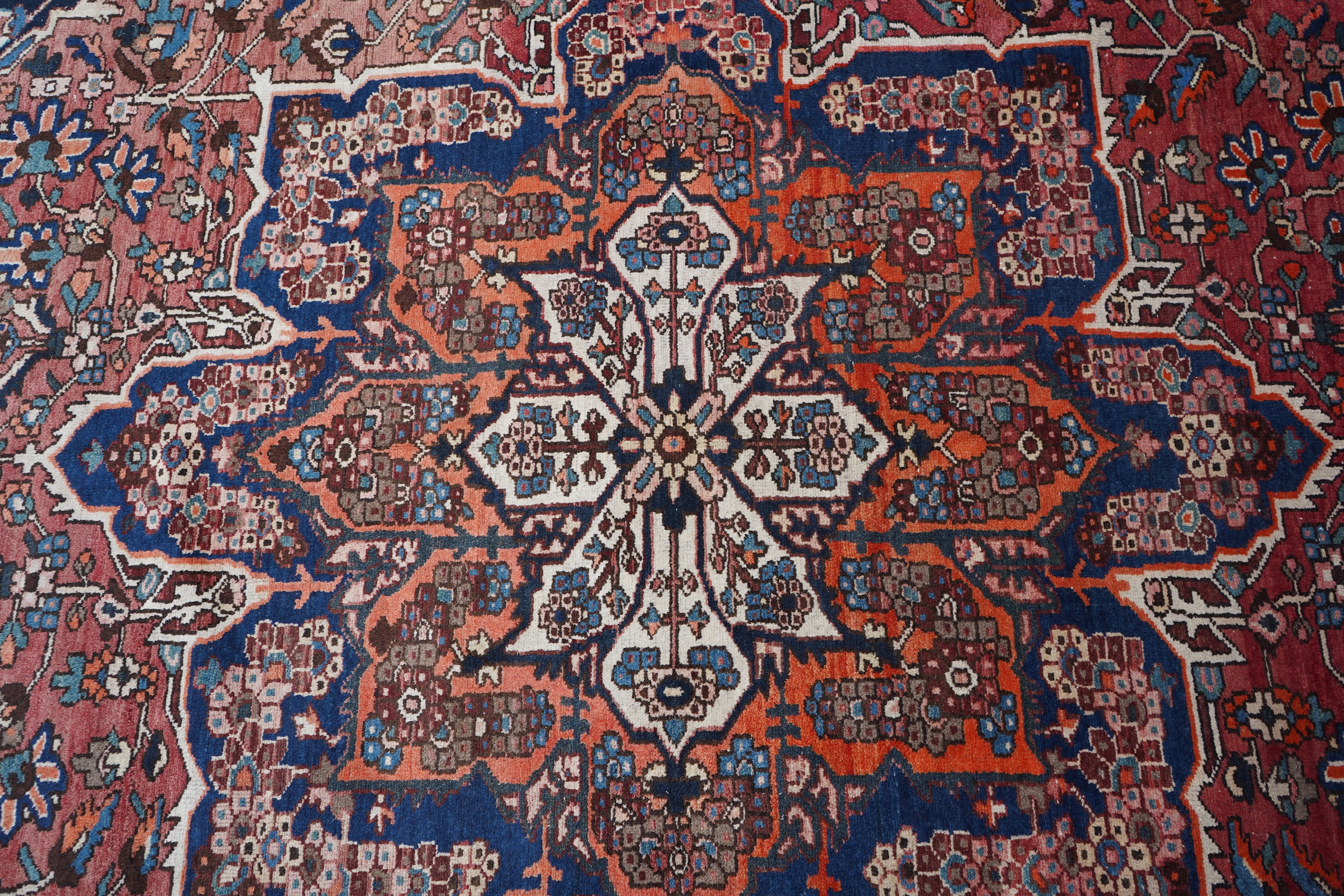 A Heriz brick red ground carpet